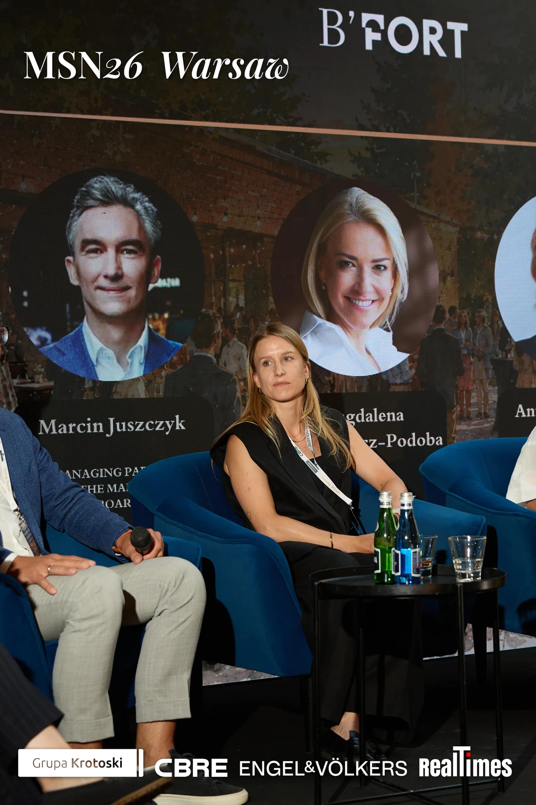 Mid-Summer Night 2026 at B'Fort, Warsaw: seated moderator + panelists on stage, daytime