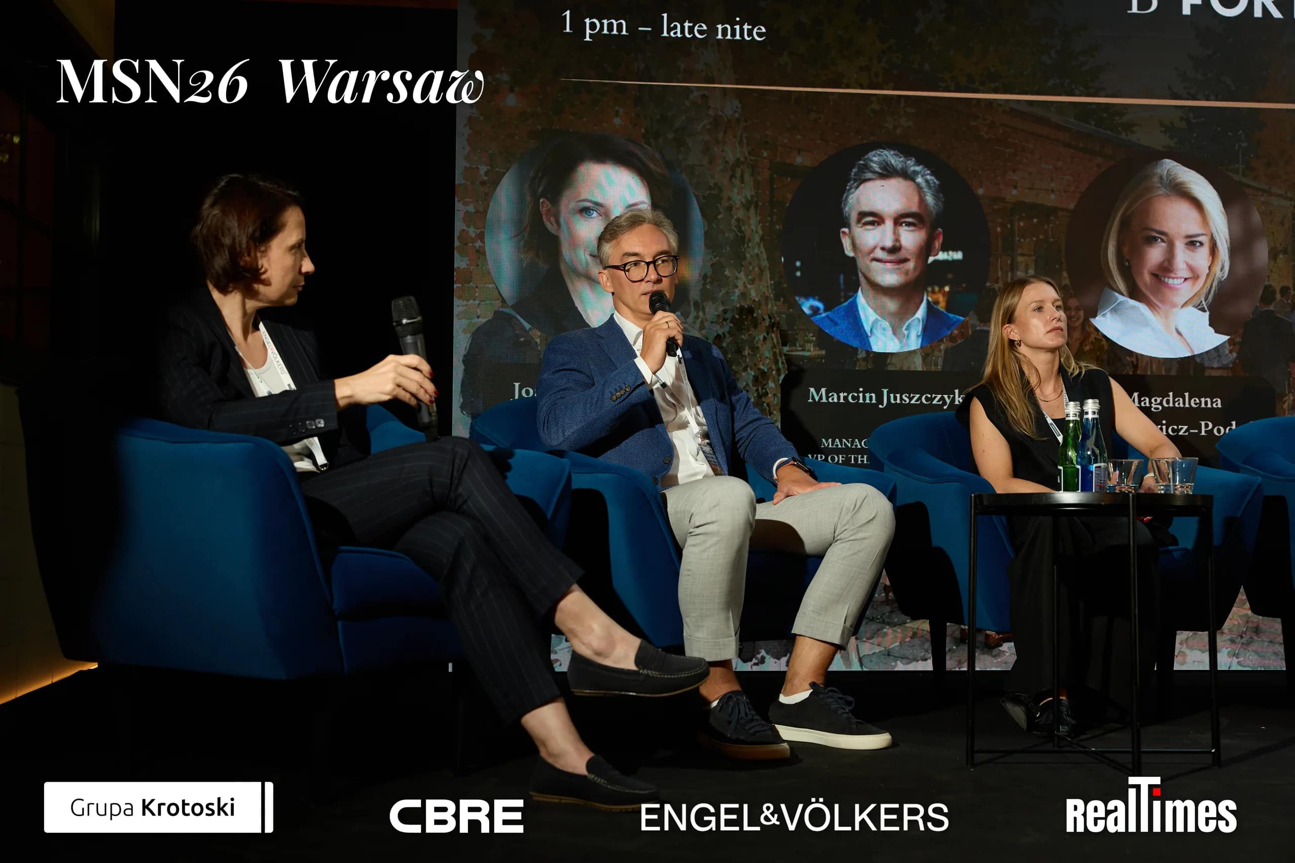 Mid-Summer Night 2026 at B'Fort, Warsaw: panel group photo standing on stage