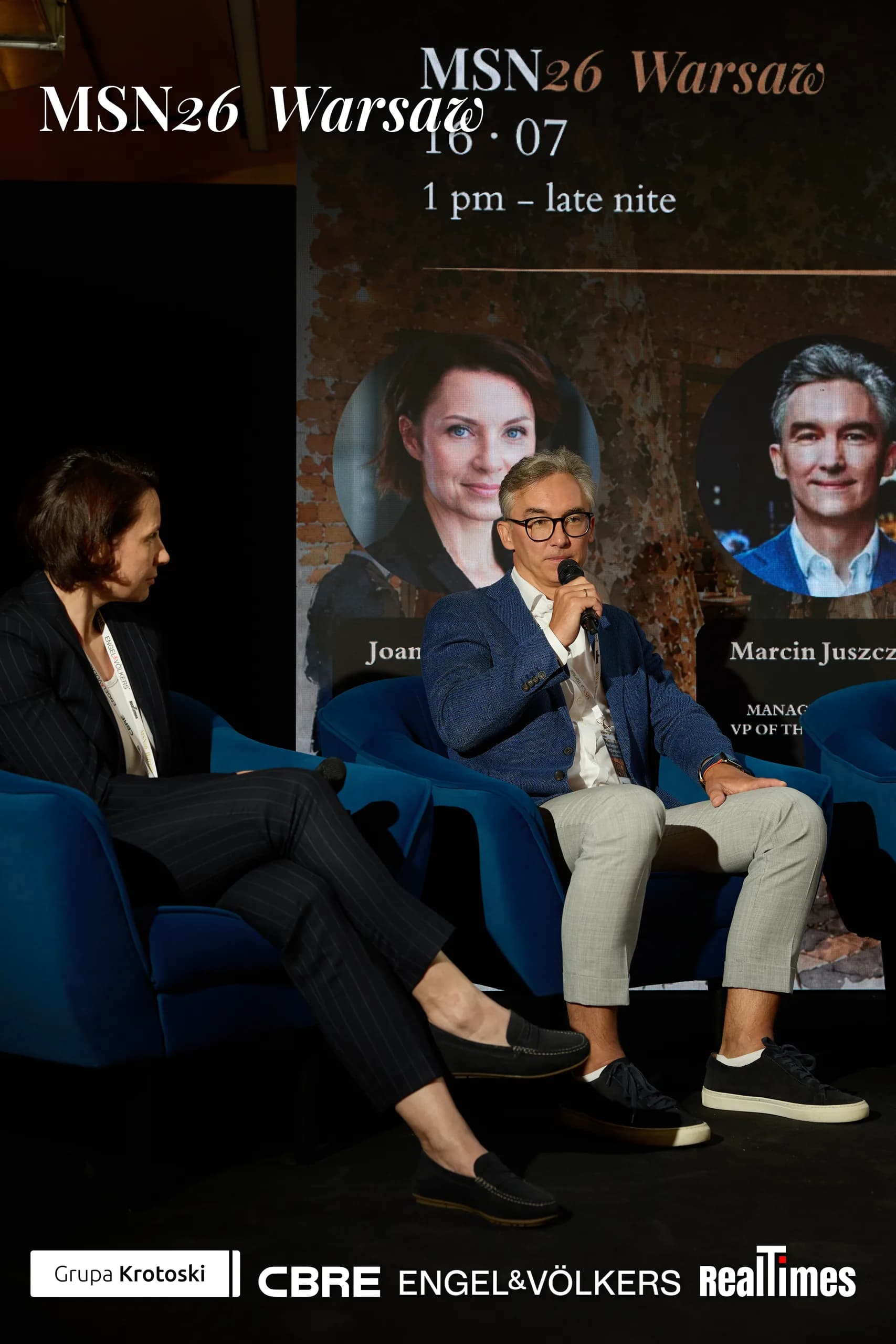 Mid-Summer Night 2026 at B'Fort, Warsaw: moderator + panelist on stage armchairs