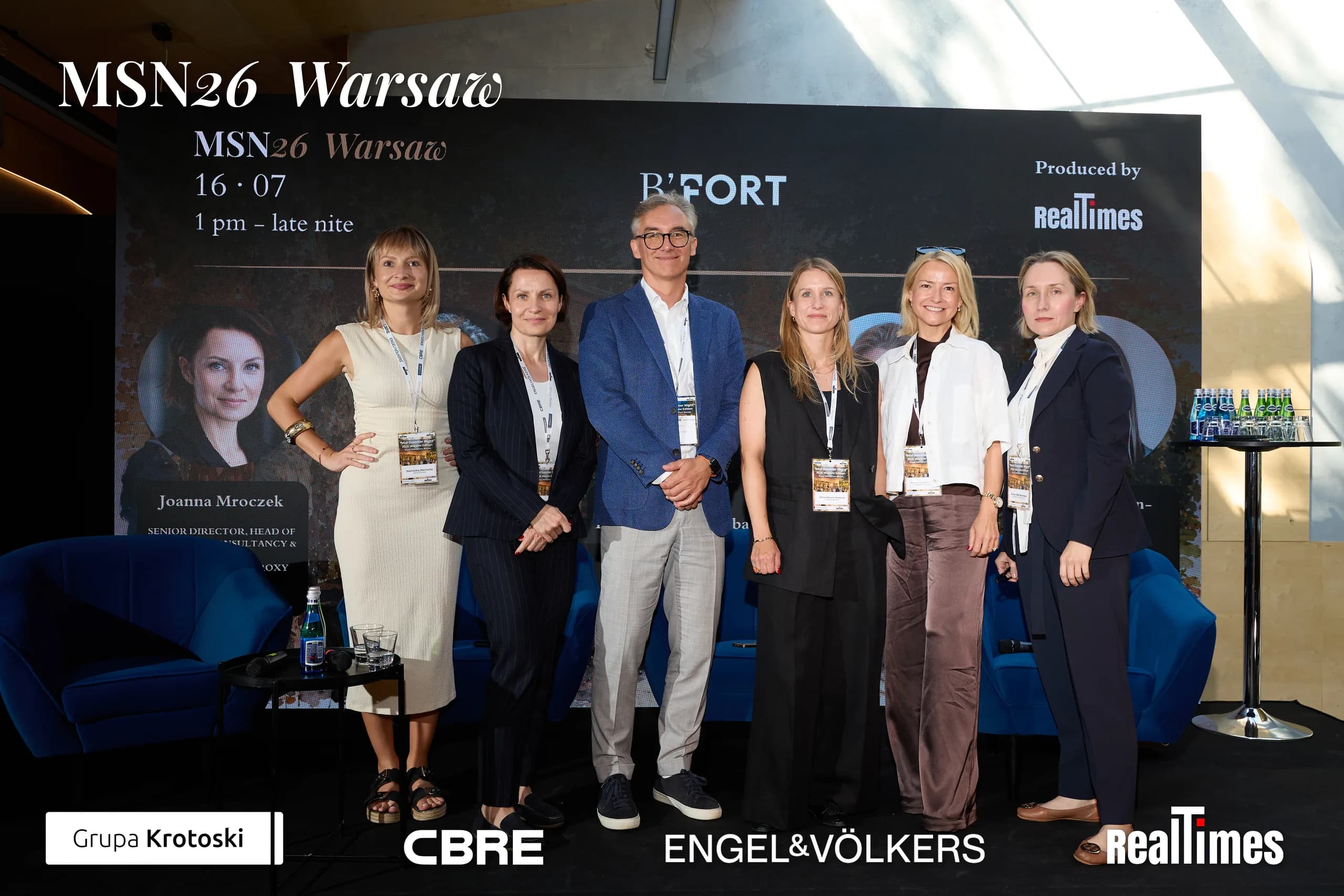 Mid-Summer Night 2026 at B'Fort, Warsaw: six-person panel group photo on stage