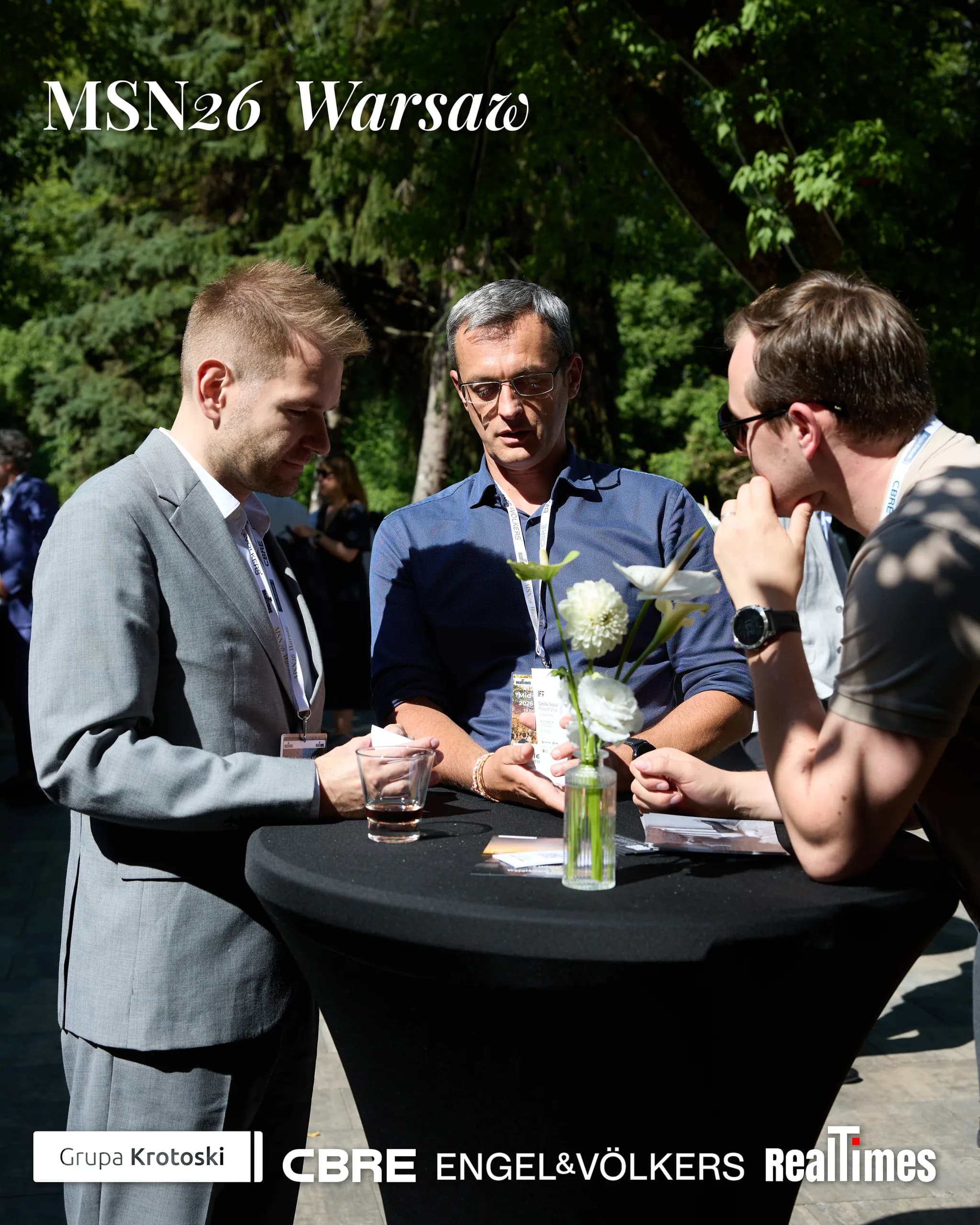 Mid-Summer Night 2026 at B'Fort, Warsaw: three men networking outdoors at table