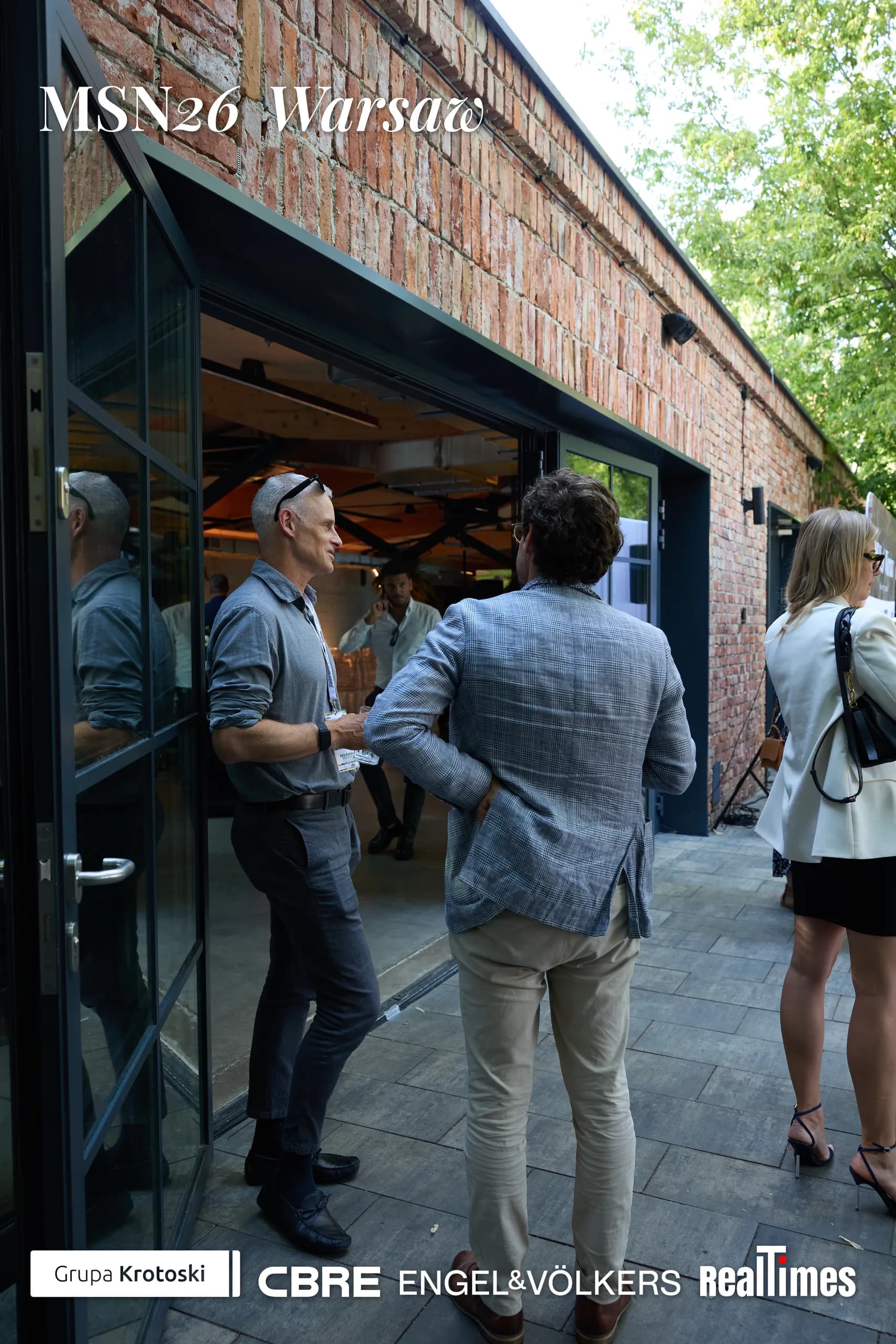 Mid-Summer Night 2026 at B'Fort, Warsaw: men shaking hands at venue doorway