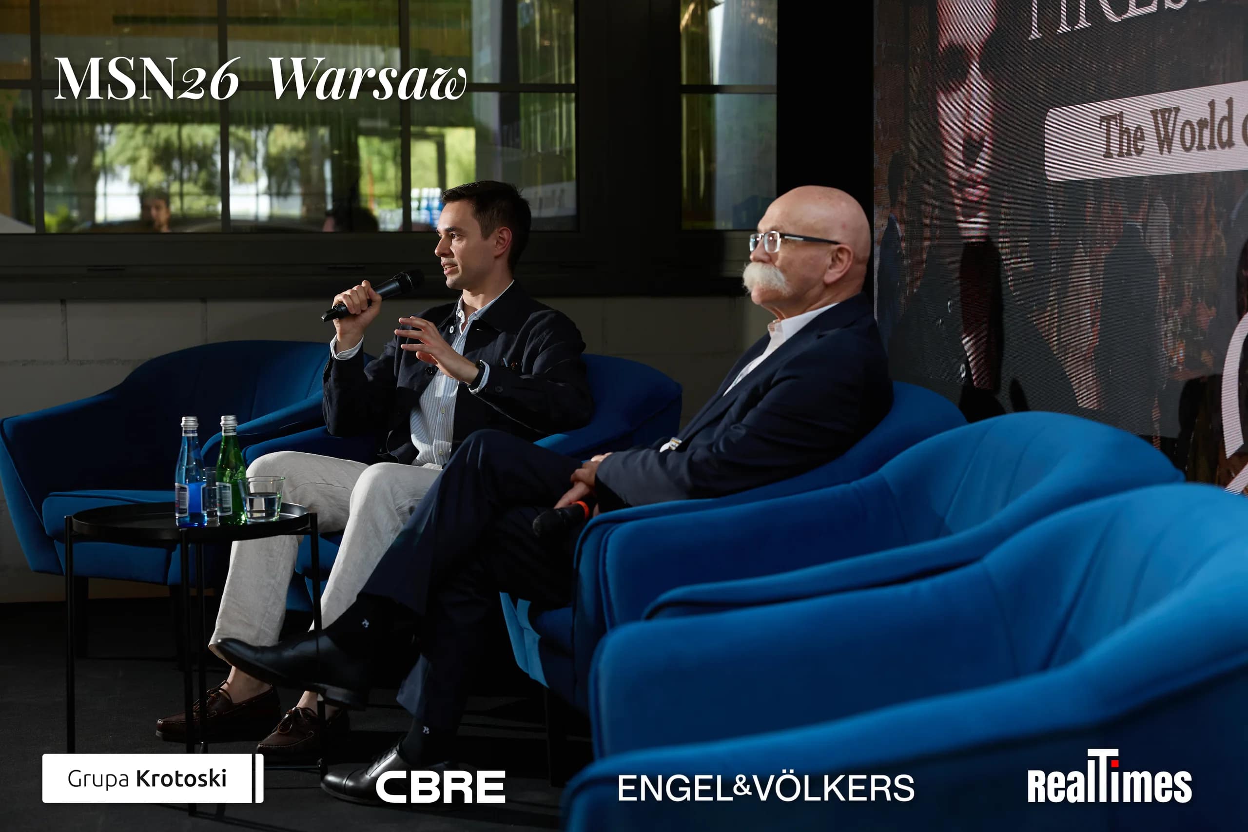 Mid-Summer Night 2026 at B'Fort, Warsaw: two seated in armchairs, fireside stage