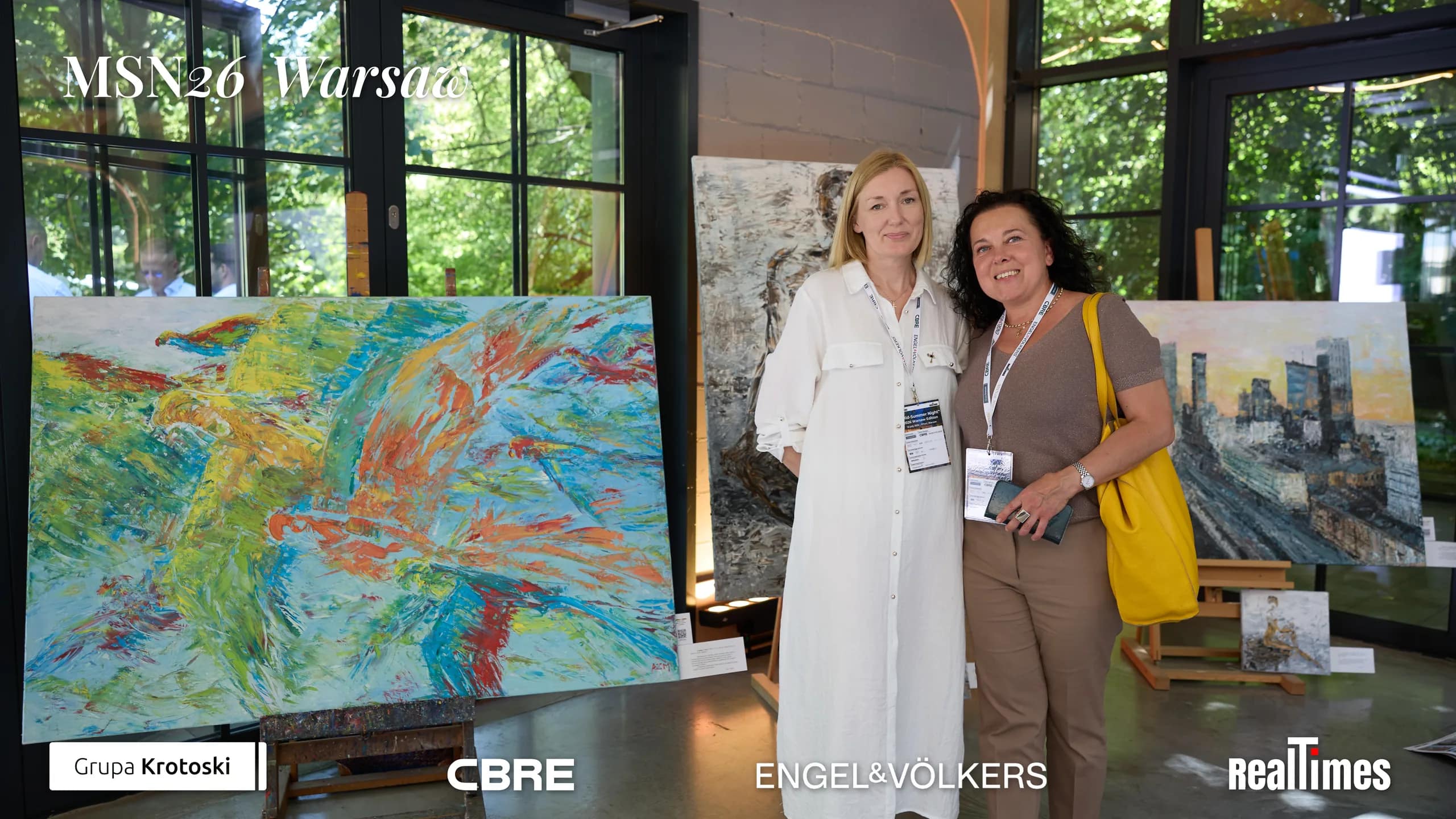 Mid-Summer Night 2026 at B'Fort, Warsaw: two women posing by art paintings