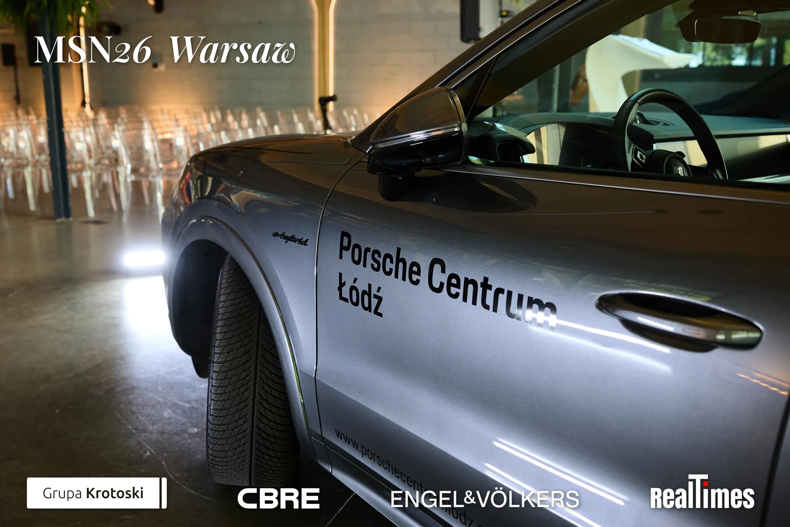 Mid-Summer Night 2026 at B'Fort, Warsaw: Porsche car indoors, empty session chairs