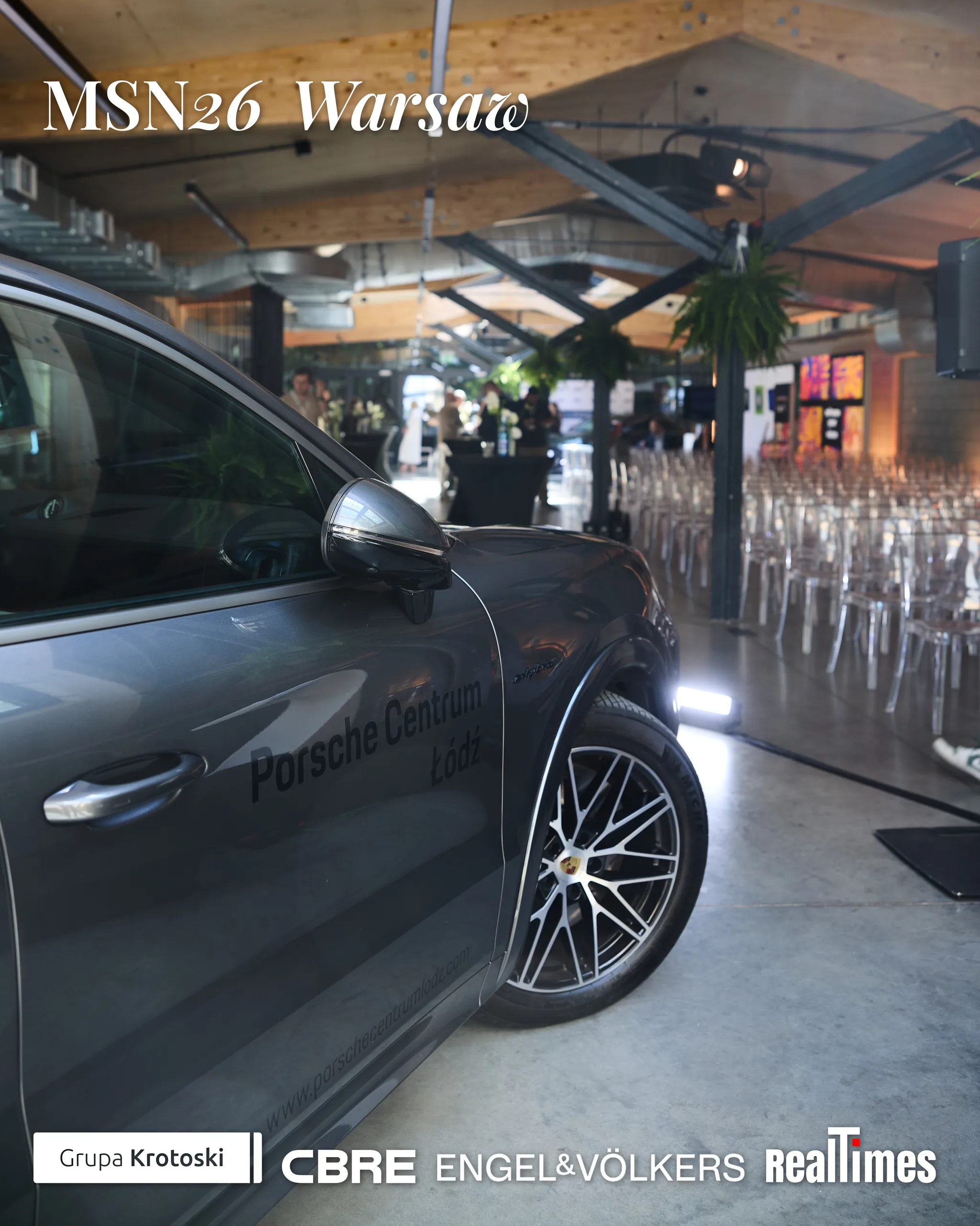 Mid-Summer Night 2026 at B'Fort, Warsaw: Porsche car in venue hall, chairs set up