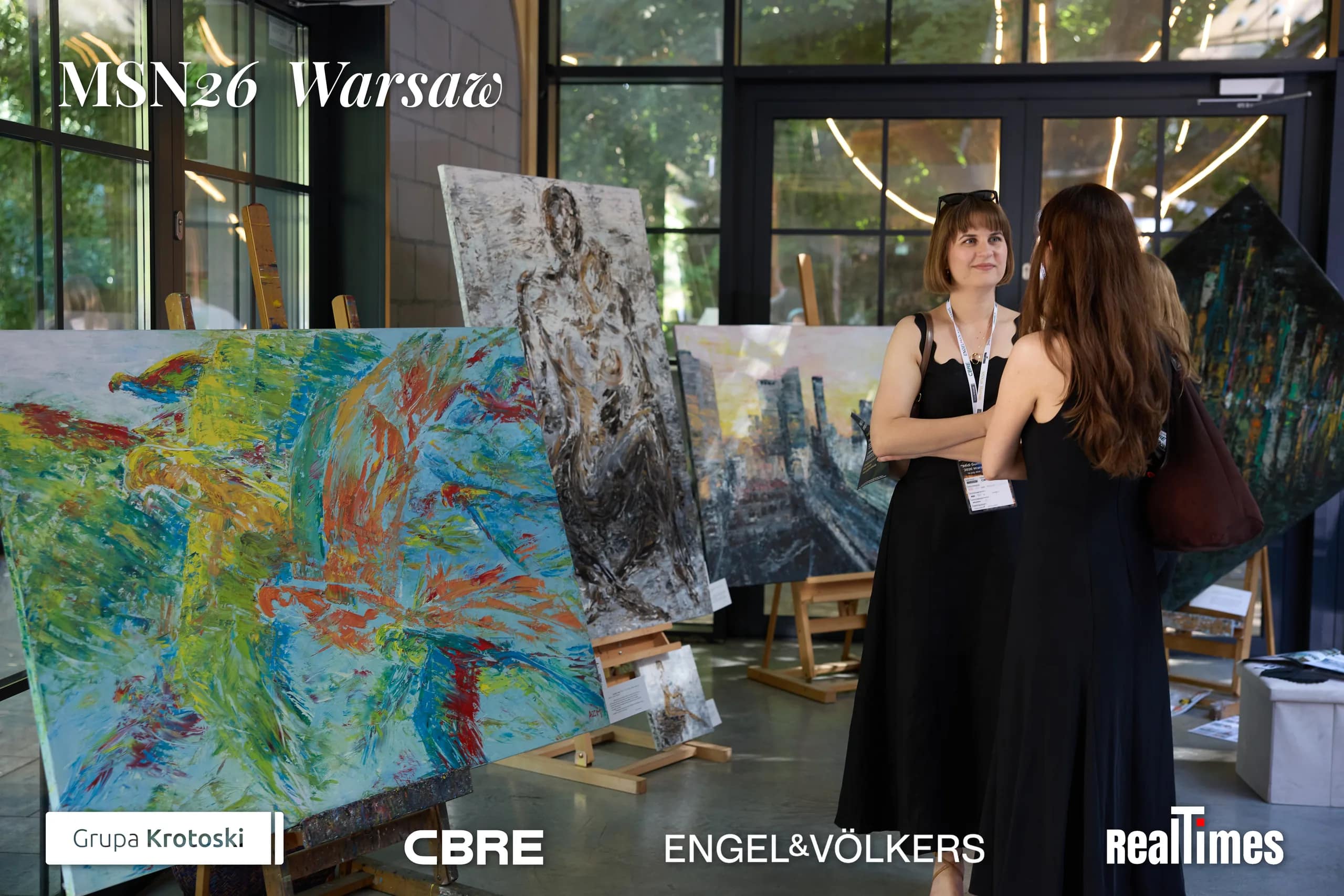 Mid-Summer Night 2026 at B'Fort, Warsaw: guests viewing paintings at the indoor art exhibition
