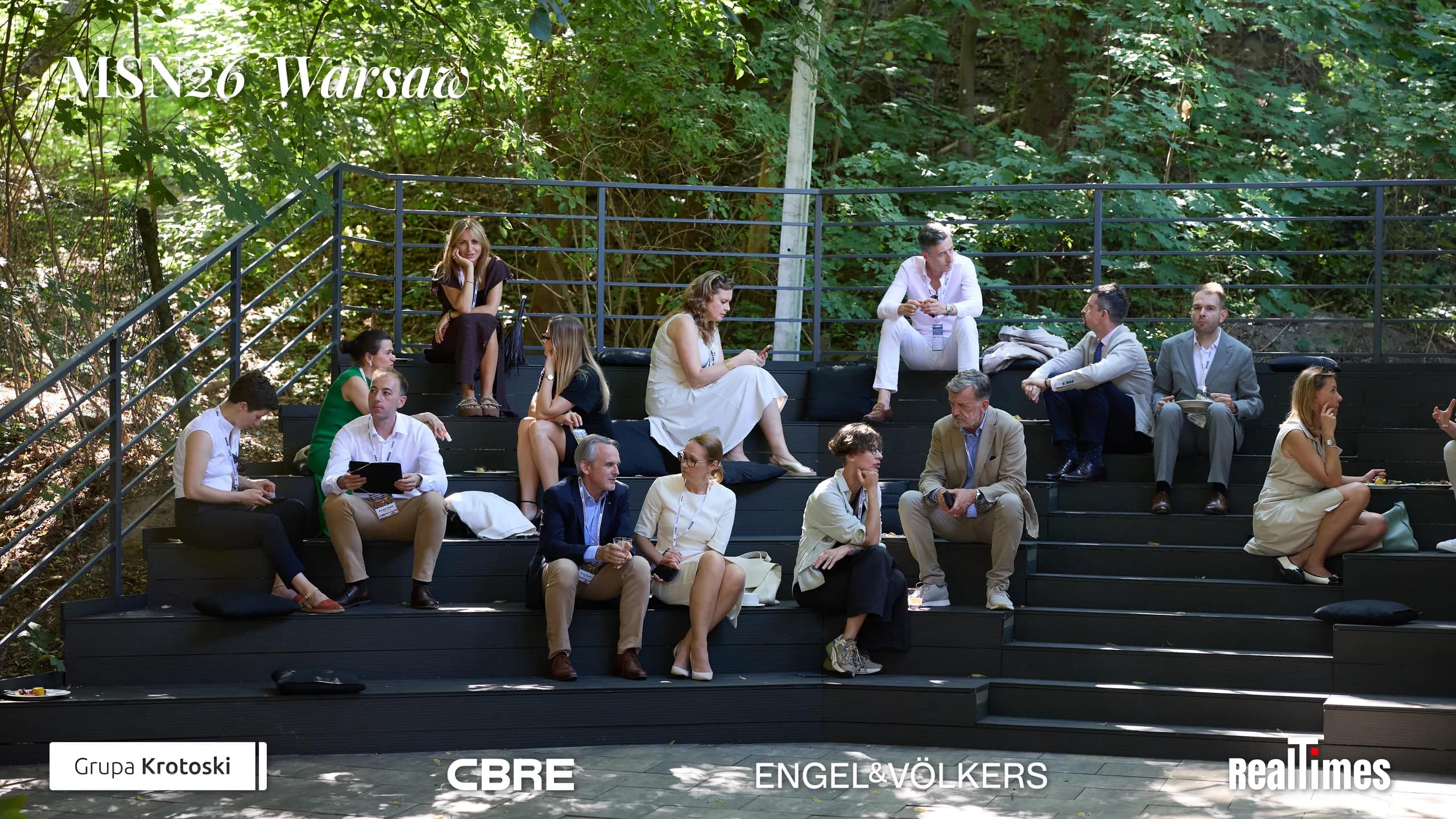 Mid-Summer Night 2026 at B'Fort, Warsaw: guests relaxing on outdoor amphitheatre steps