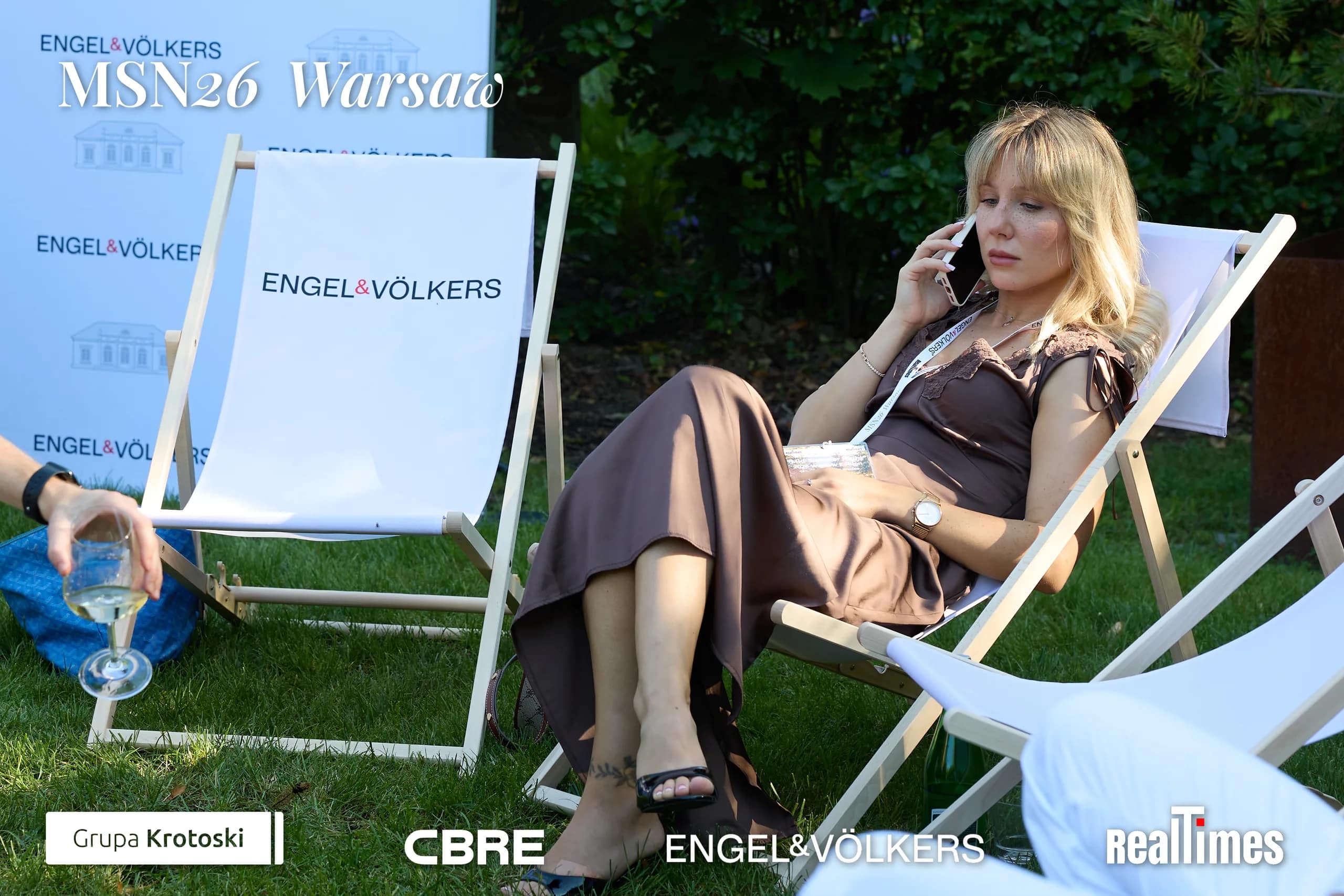Mid-Summer Night 2026 at B'Fort, Warsaw: woman lounging in deckchair on phone