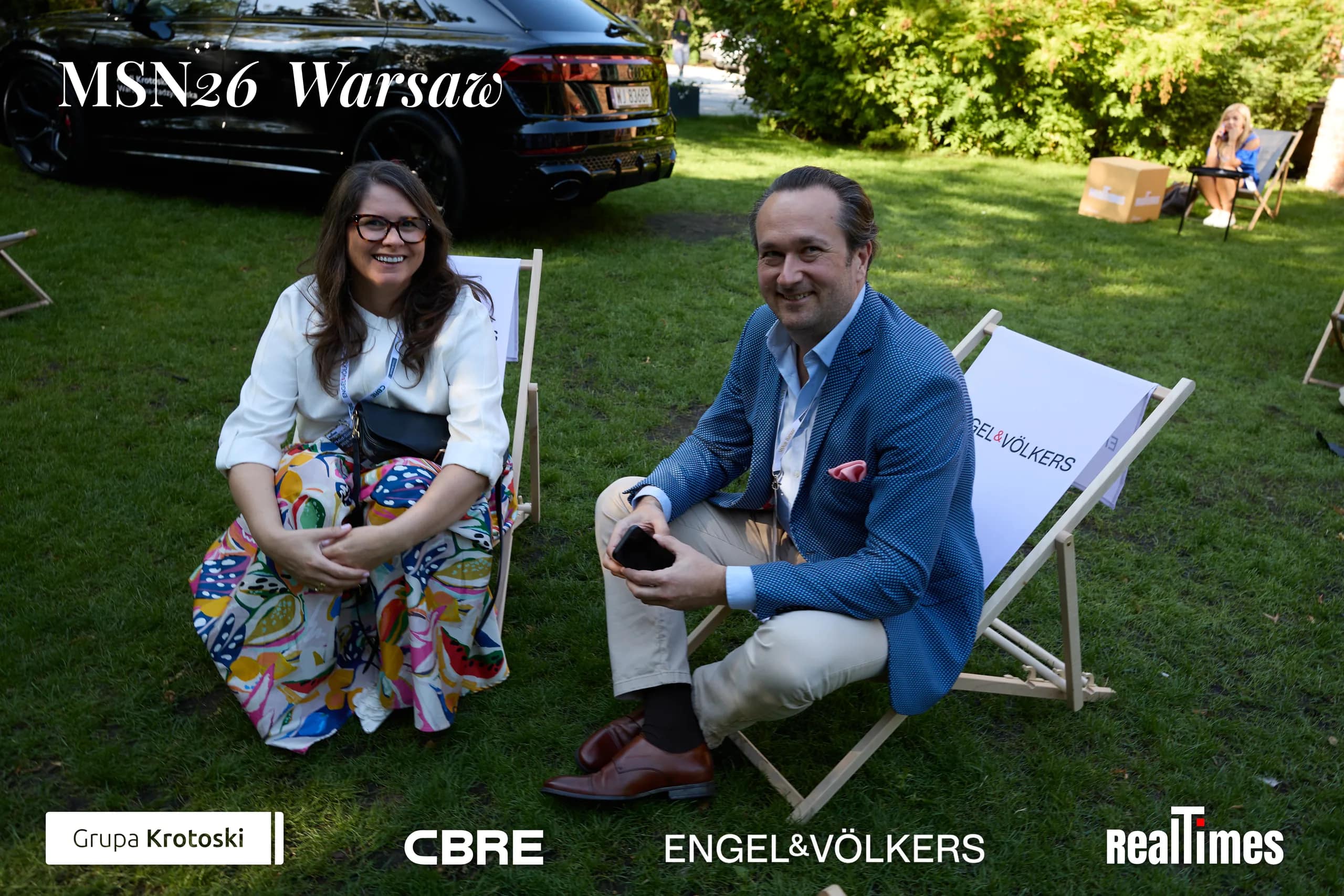 Mid-Summer Night 2026 at B'Fort, Warsaw: two guests in garden deckchairs, networking