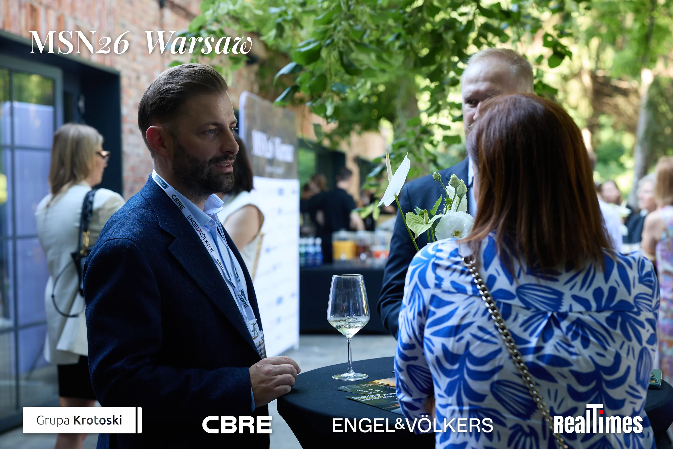 Mid-Summer Night 2026 at B'Fort, Warsaw: guests mingling with wine, courtyard networking
