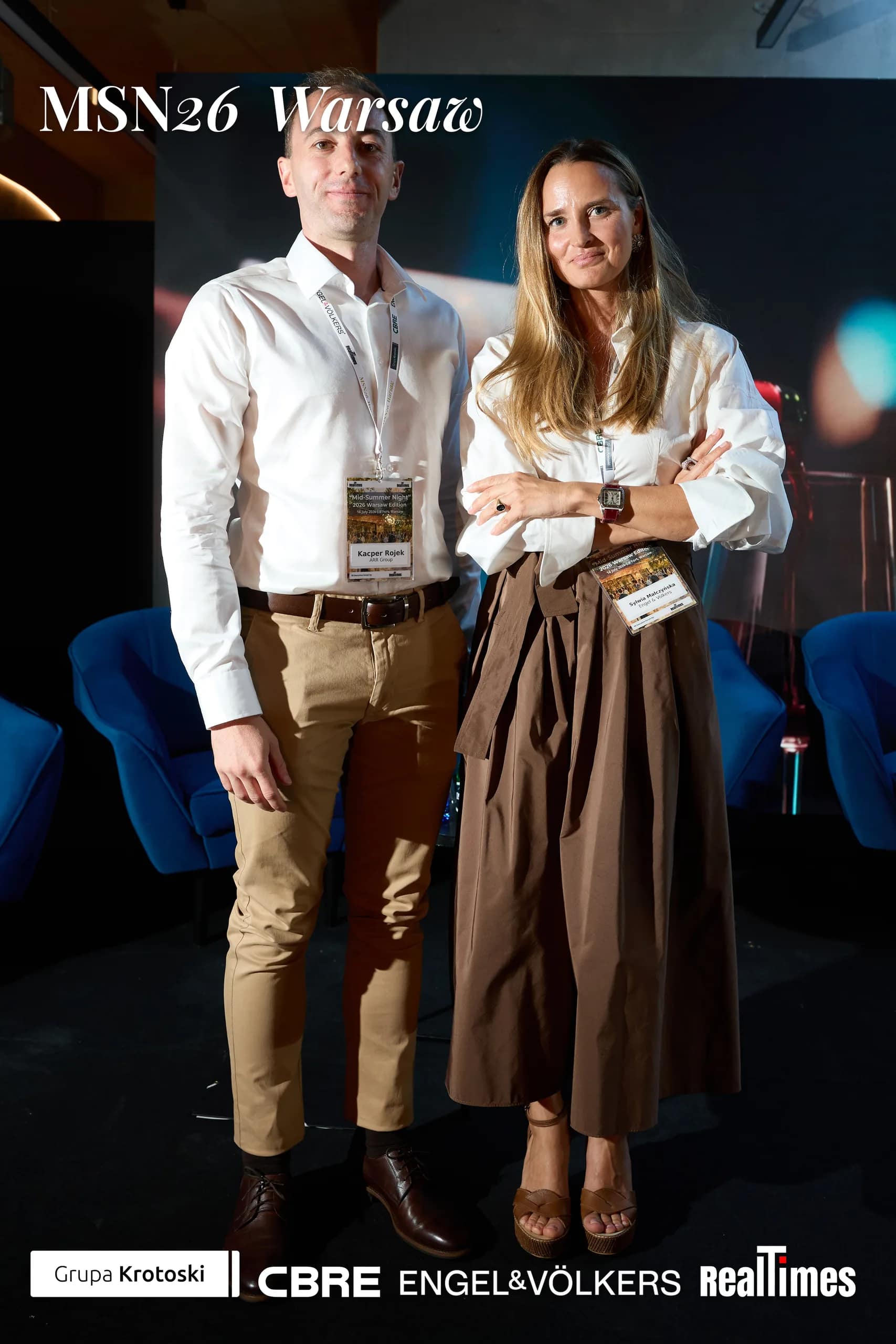 Mid-Summer Night 2026 at B'Fort, Warsaw: pair posed before Phoenix Awards backdrop | QA-adjudicated: networking/posed portrait, not stage