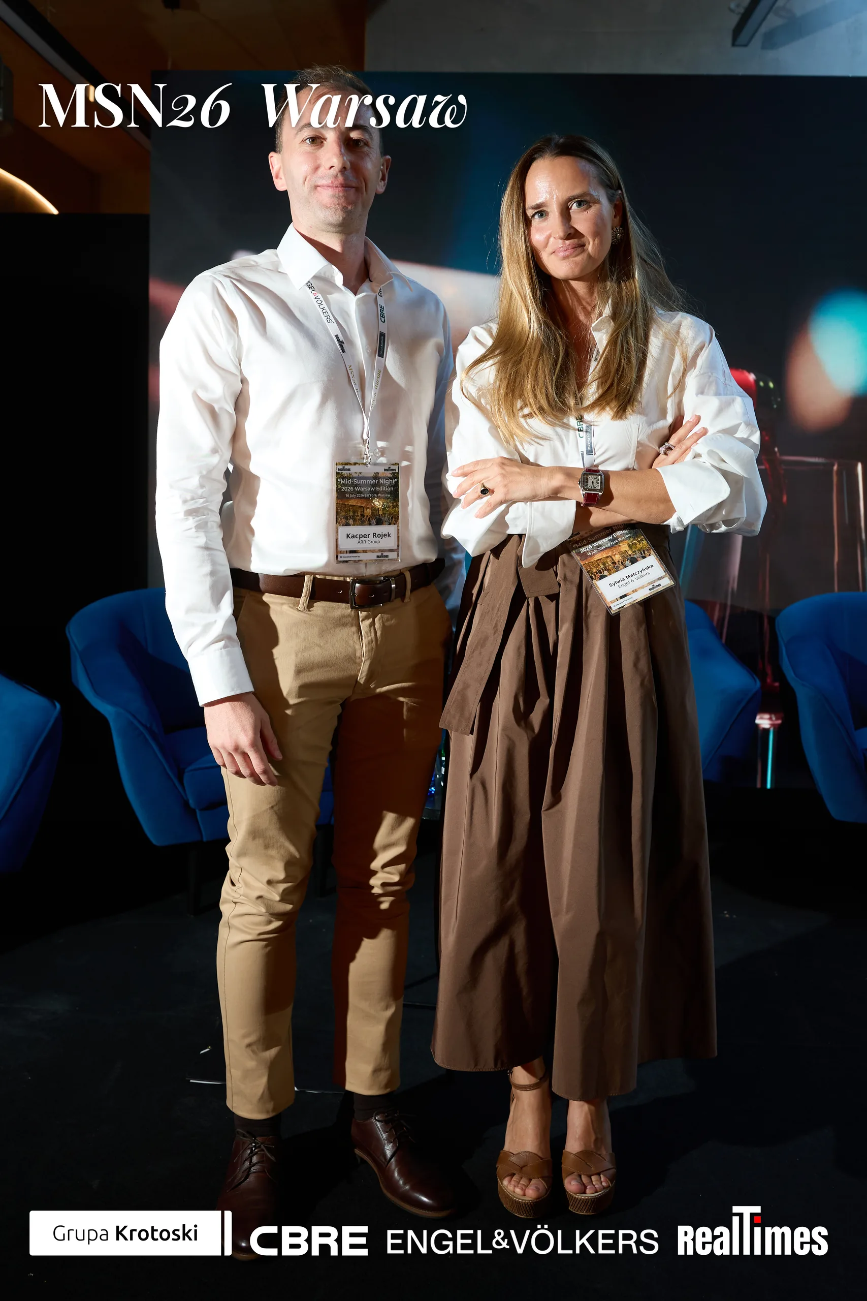 Mid-Summer Night 2026 at B'Fort, Warsaw: pair posed before Phoenix Awards backdrop | QA-adjudicated: networking/posed portrait, not stage