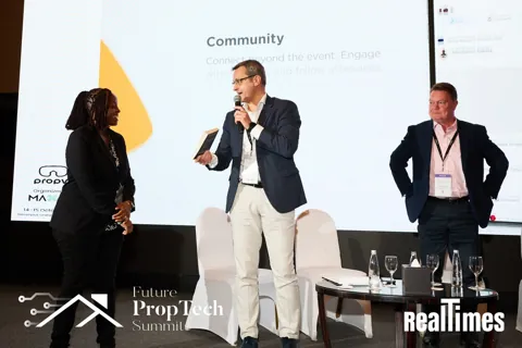 Alexander Morari welcoming a guest on stage at Future PropTech Summit 2025 in Dubai.