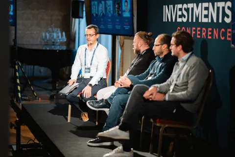 A side view of a panel moderated by Alexander Morari, notes in hand, at Engaged Investments 2023 in Prague.