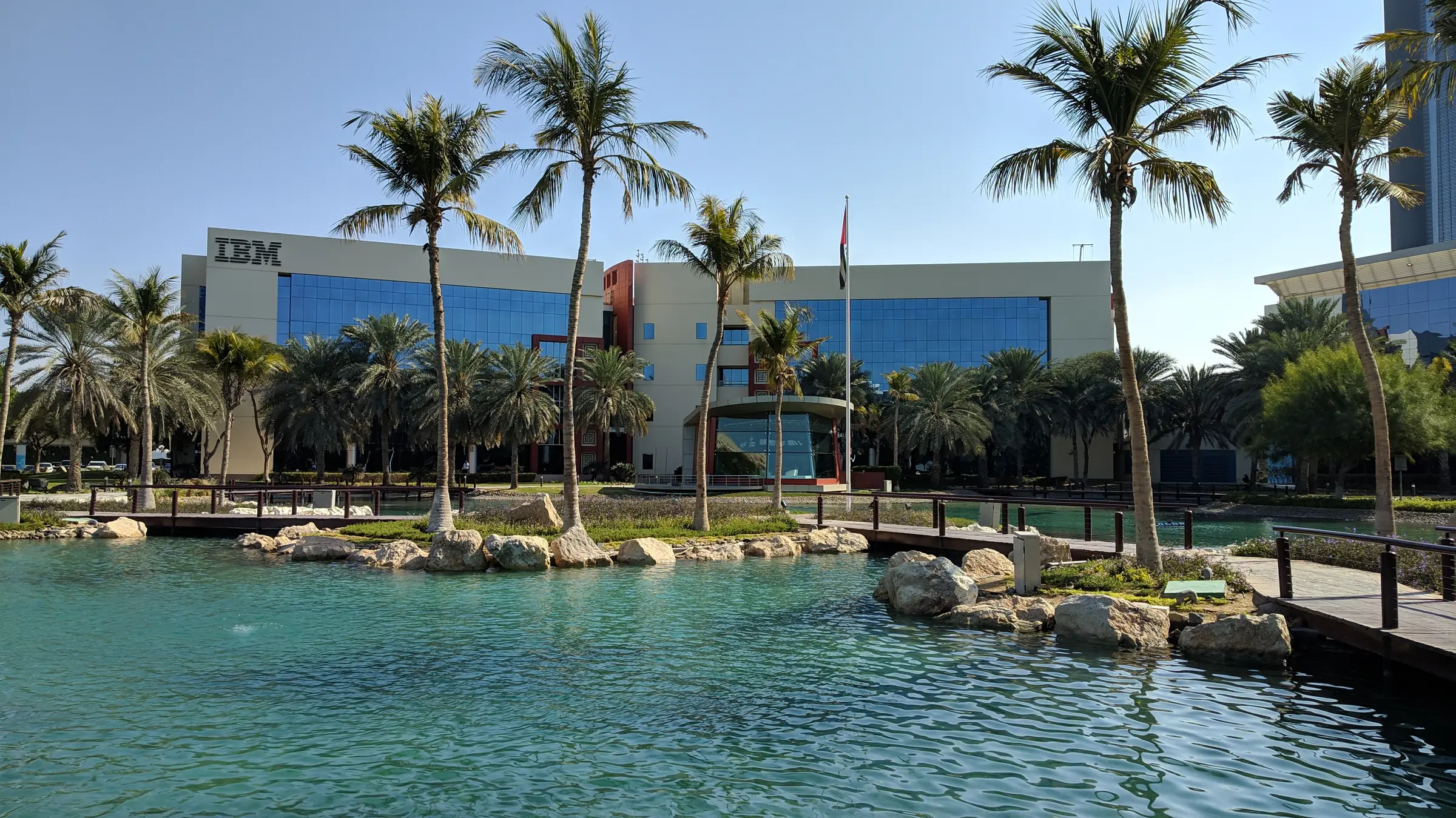 Glass office campus beside a lagoon at Dubai Internet City, a free-zone setting built for new kinds of workspace