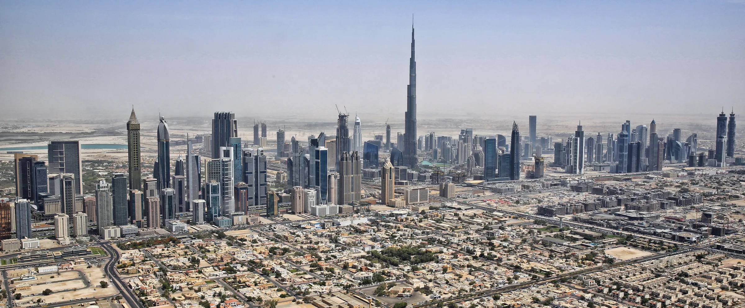 Aerial view of Dubai's skyline and Burj Khalifa, the city whose office market the peak question covers