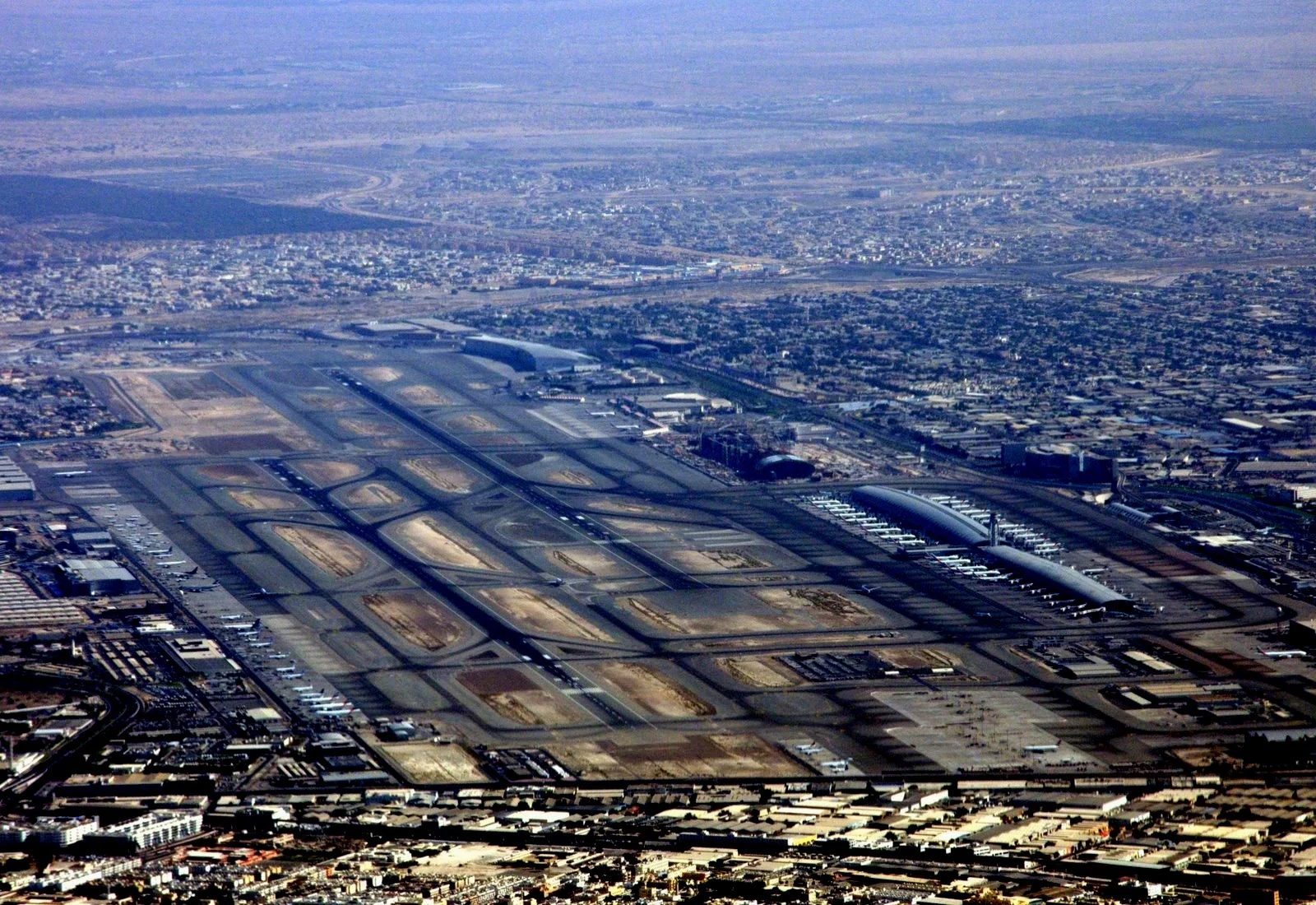 Aerial view of Dubai International Airport and its runways, the airport that sits beside Dubai CommerCity