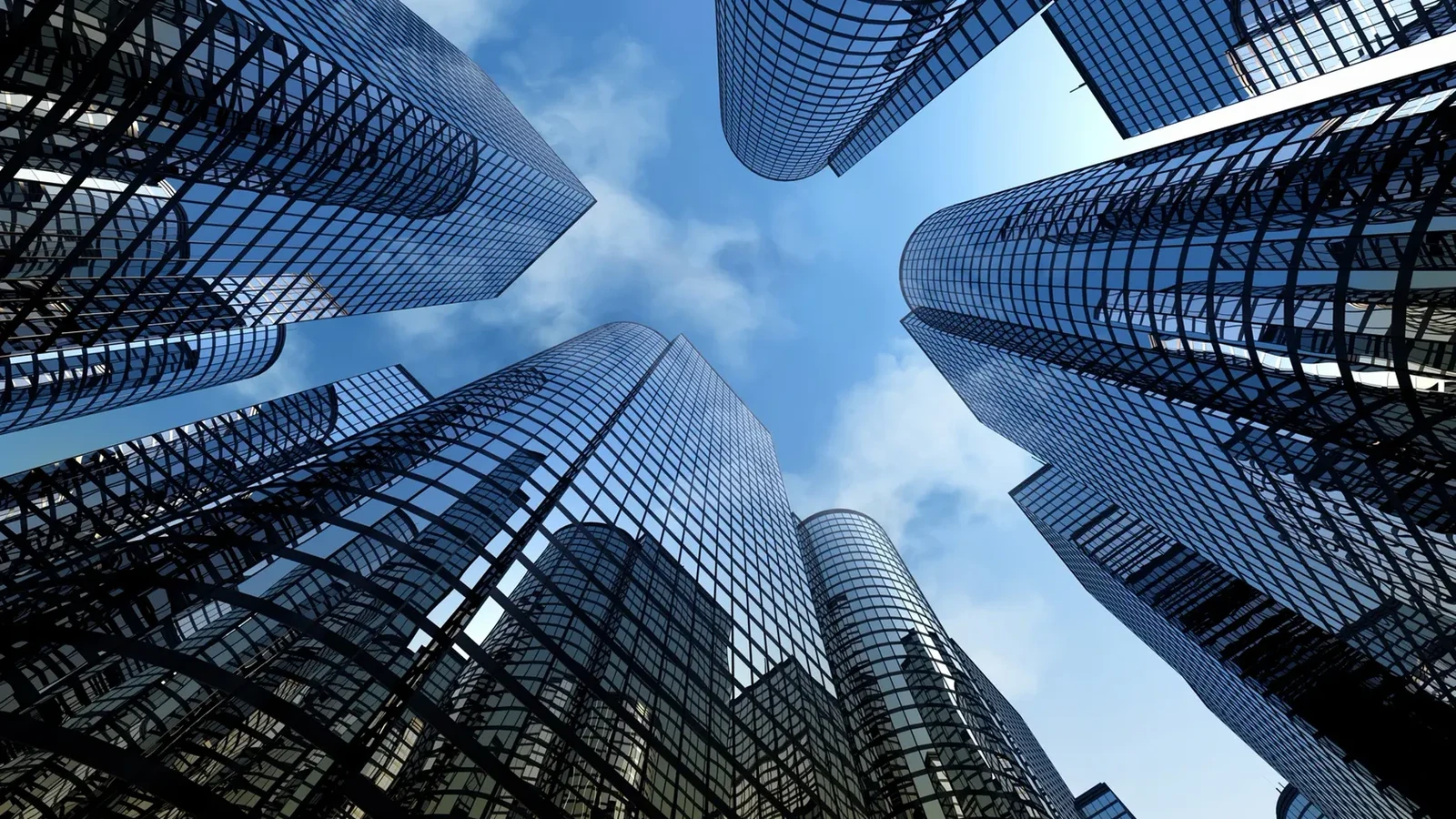 Glass office towers rising into a clear sky