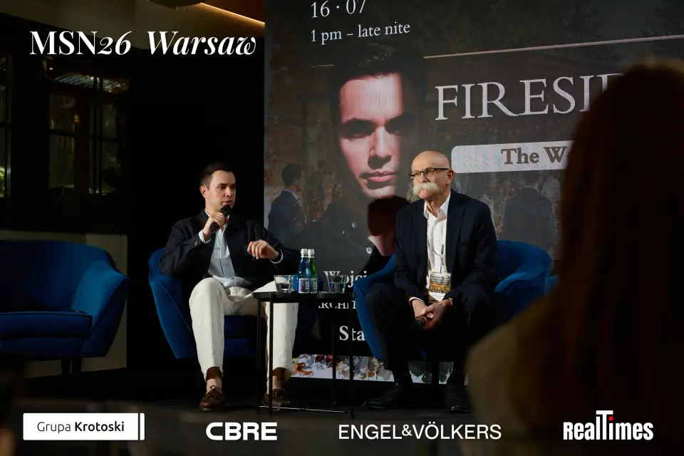 Mid-Summer Night 2026 at B'Fort, Warsaw: Fireside screen, two seated in armchairs