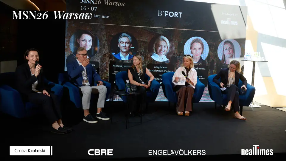 Mid-Summer Night 2026 at B'Fort, Warsaw: 5 panelists in row on stage, headshot backdrop