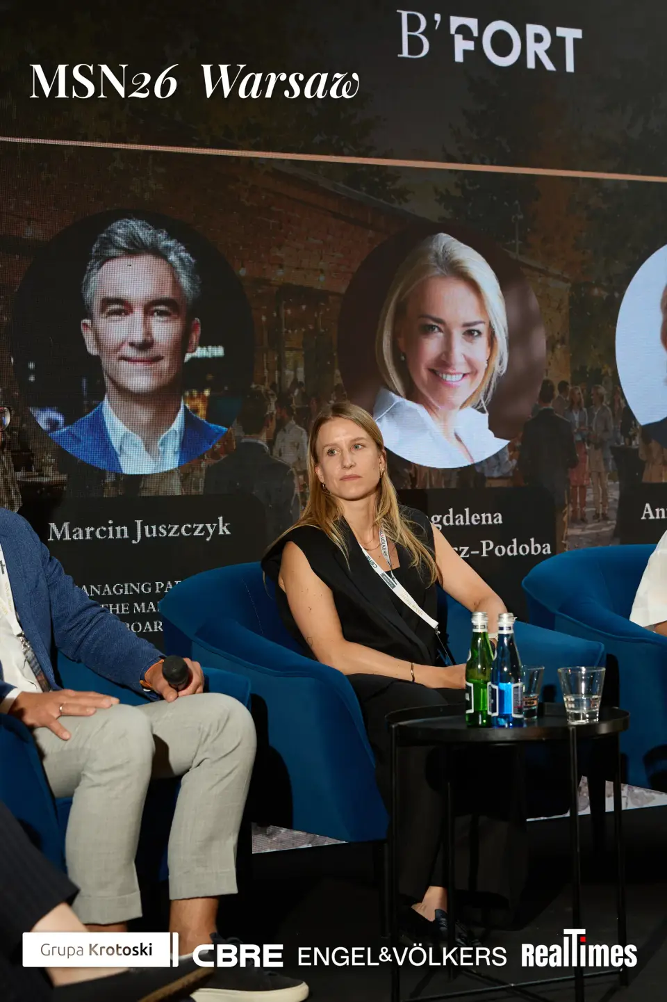 Mid-Summer Night 2026 at B'Fort, Warsaw: seated moderator + panelists on stage, daytime