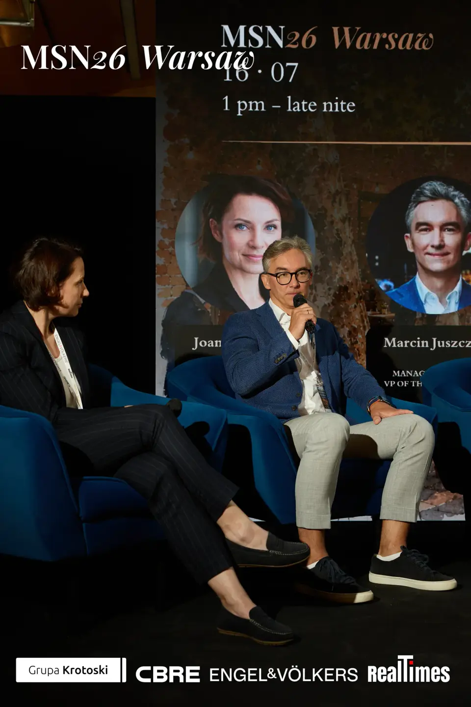 Mid-Summer Night 2026 at B'Fort, Warsaw: moderator + panelist on stage armchairs