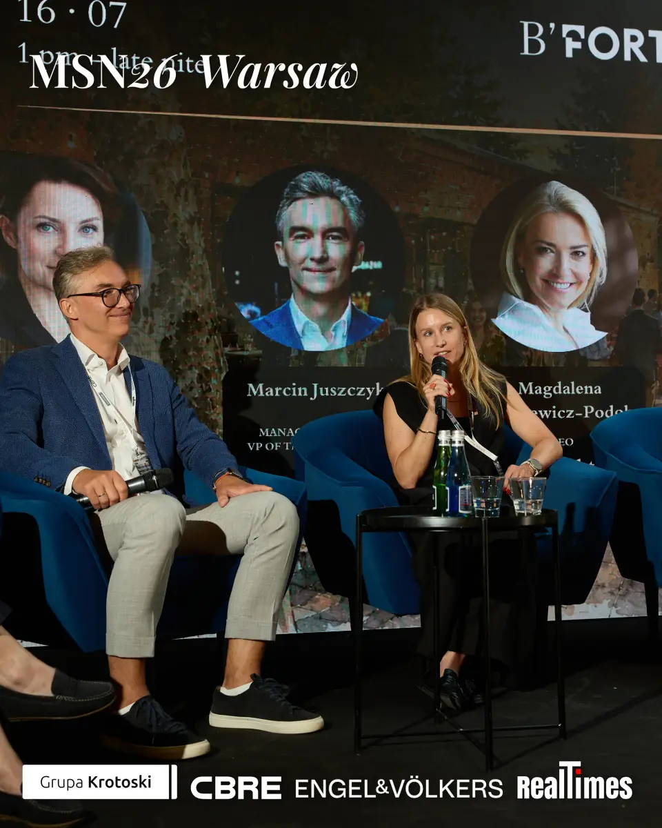Mid-Summer Night 2026 at B'Fort, Warsaw: panelist speaking, same speaker cards behind