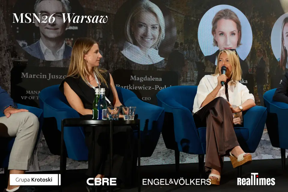 Mid-Summer Night 2026 at B'Fort, Warsaw: two panelists seated, mic, same panel
