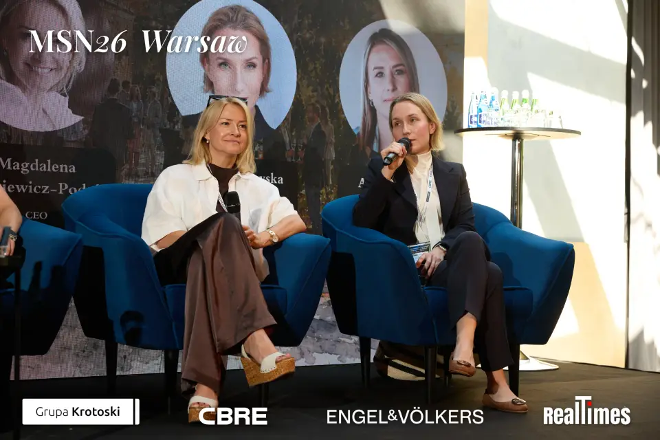 Mid-Summer Night 2026 at B'Fort, Warsaw: two panelists seated, mic, same panel
