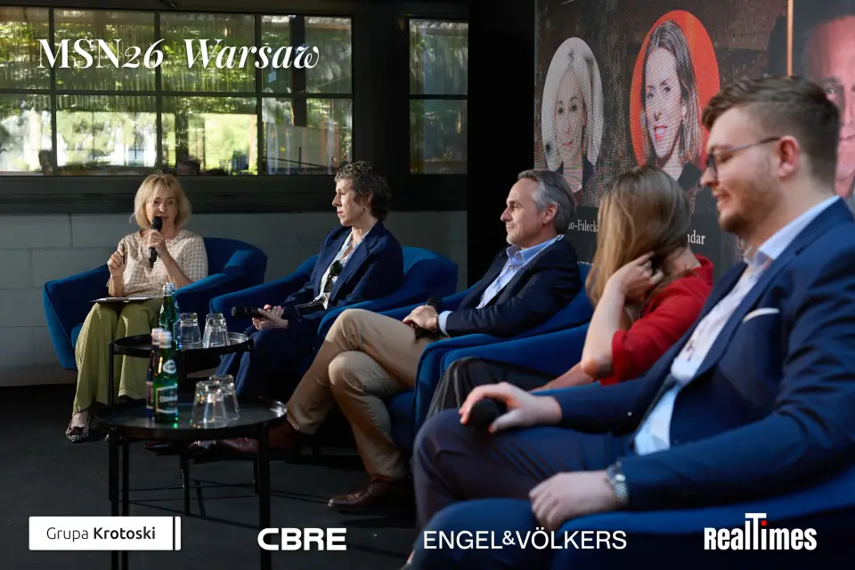 Mid-Summer Night 2026 at B'Fort, Warsaw: panelists row with audience foreground