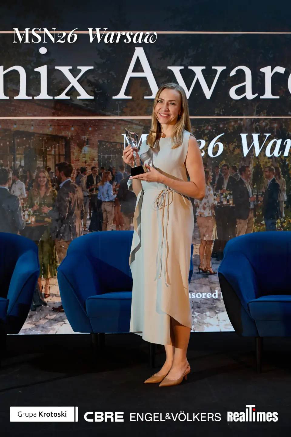 Mid-Summer Night 2026 at B'Fort, Warsaw: woman posing with trophy, awards backdrop