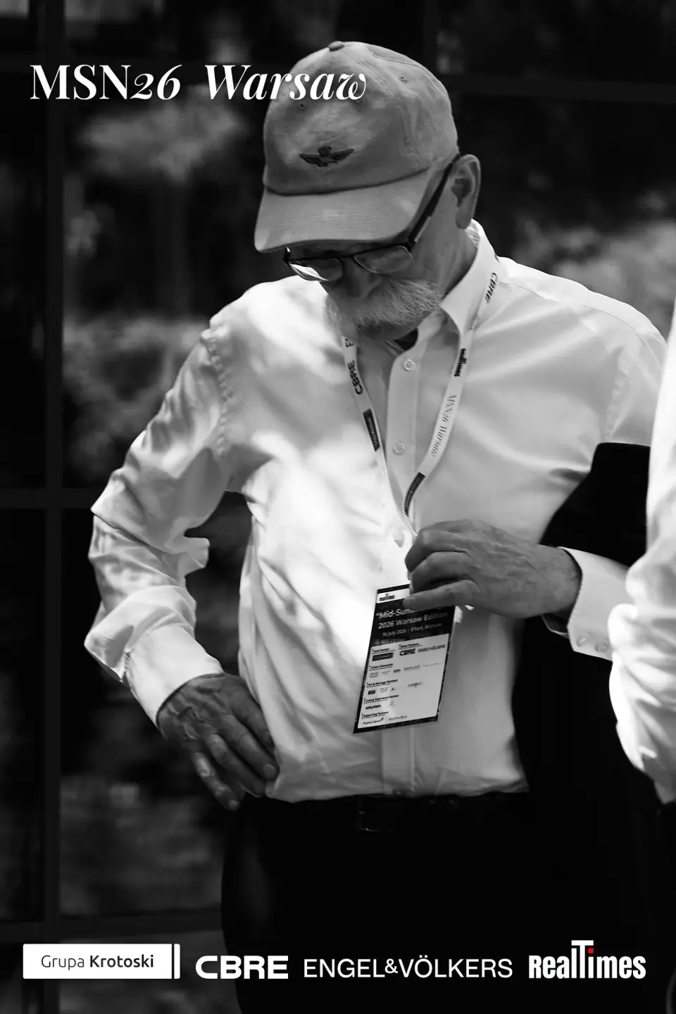 Mid-Summer Night 2026 at B'Fort, Warsaw: attendee adjusting badge, B&W portrait
