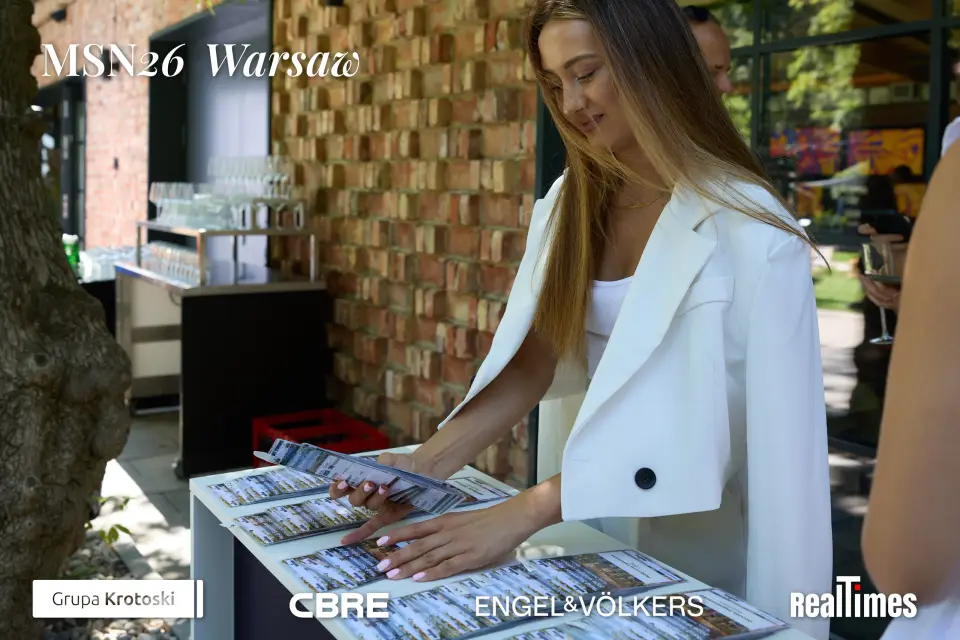 Mid-Summer Night 2026 at B'Fort, Warsaw: hostess arranging brochures at table