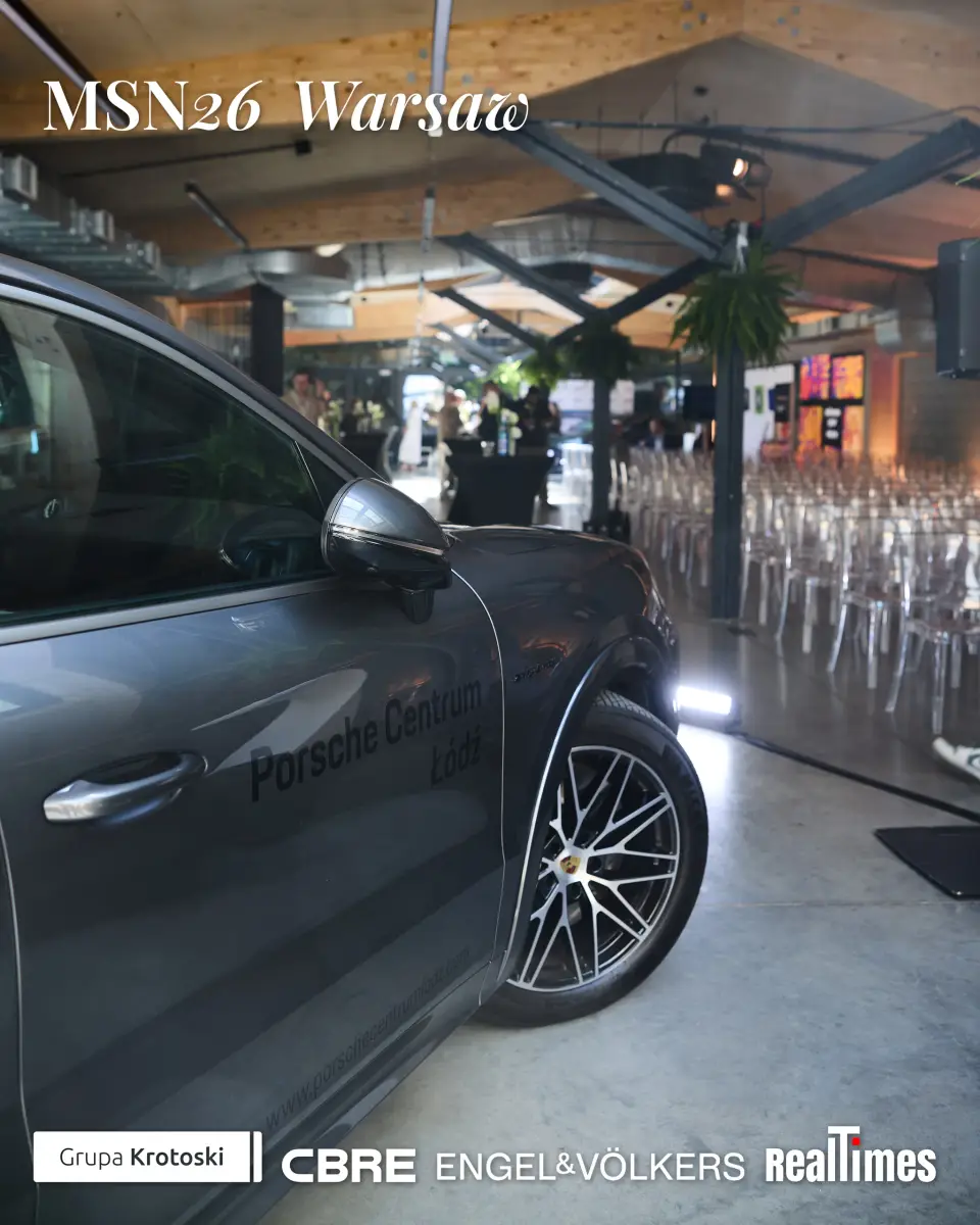 Mid-Summer Night 2026 at B'Fort, Warsaw: Porsche car in venue hall, chairs set up