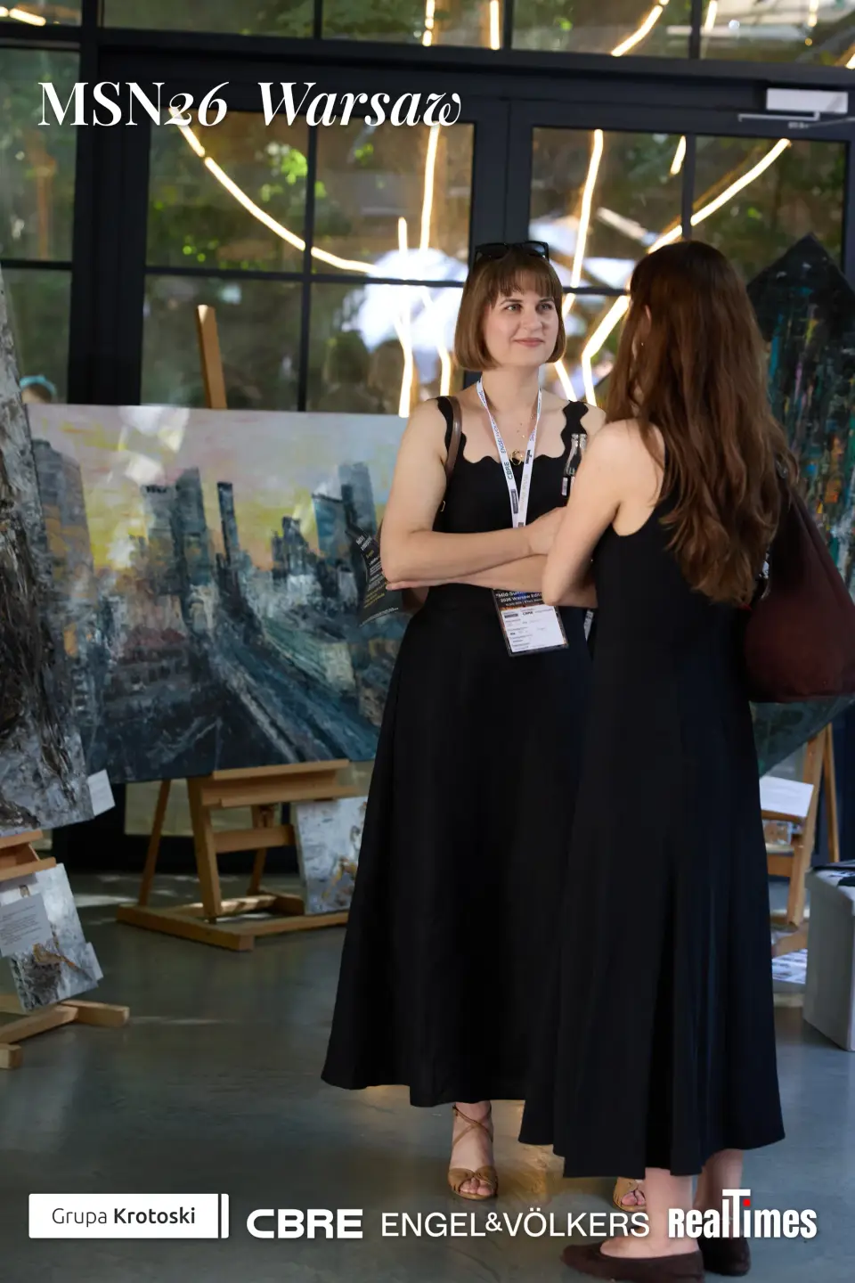 Mid-Summer Night 2026 at B'Fort, Warsaw: two women chatting at art display