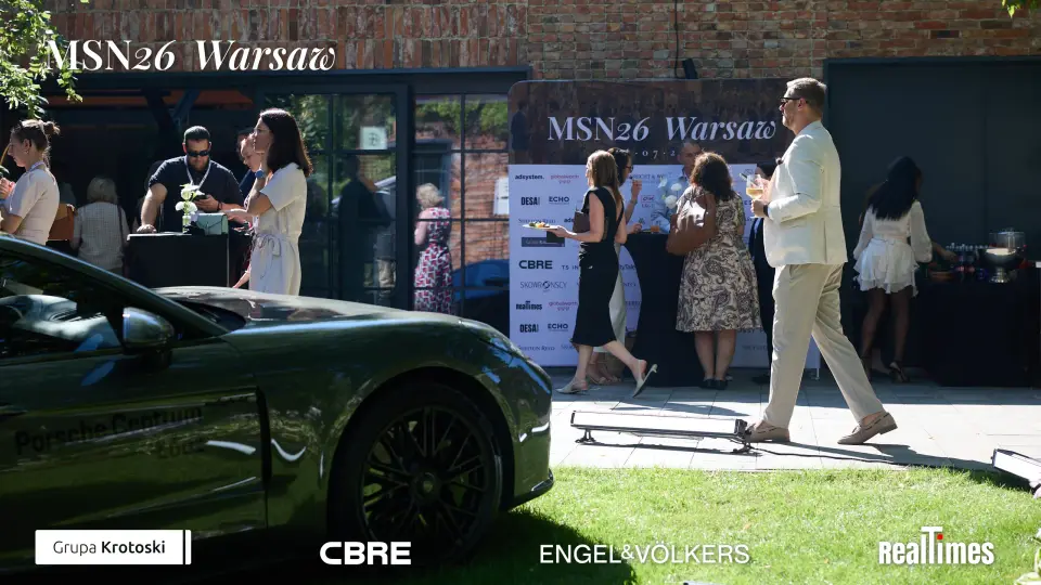 Mid-Summer Night 2026 at B'Fort, Warsaw: crowd networking by Porsche display outdoors