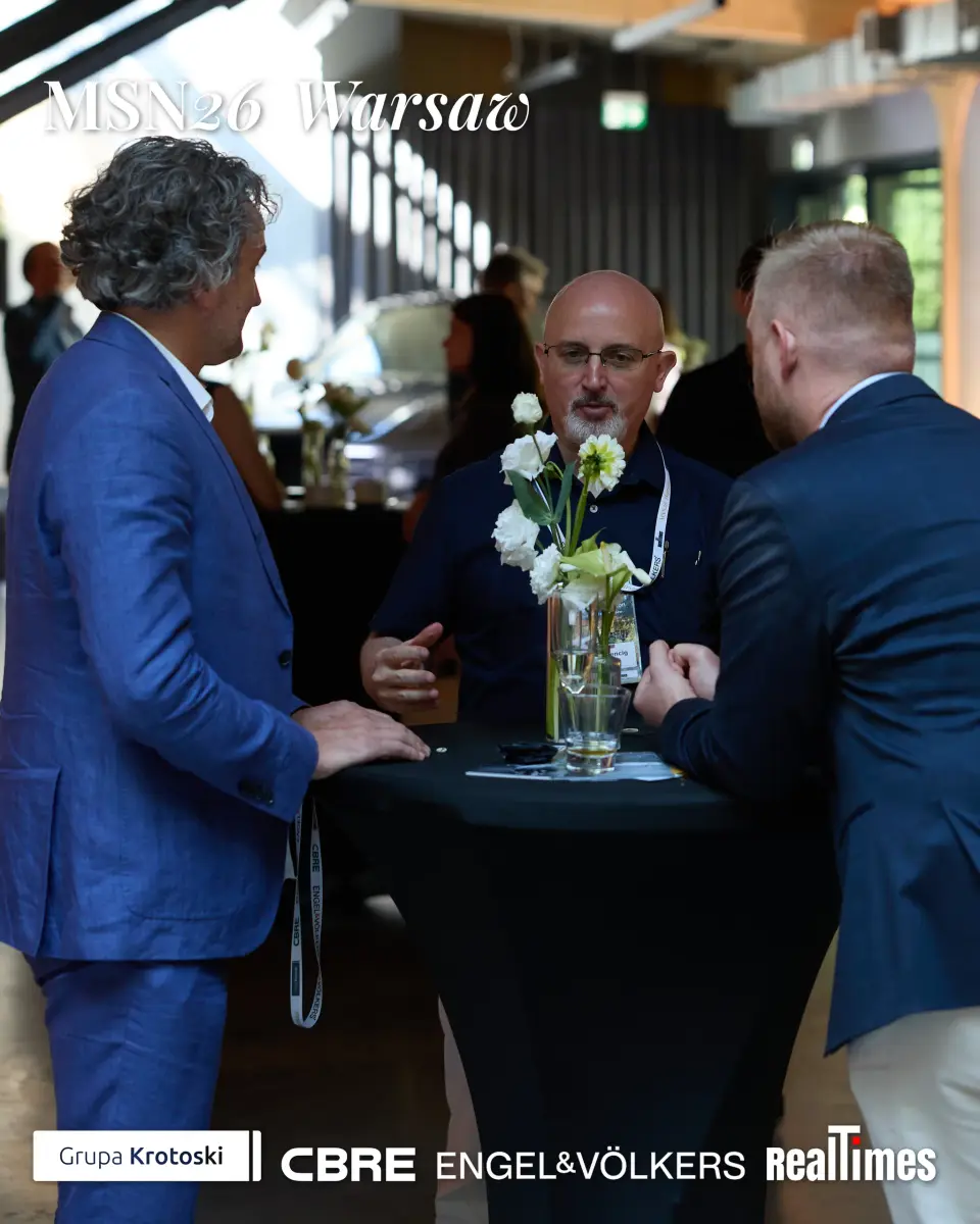 Mid-Summer Night 2026 at B'Fort, Warsaw: three men networking at standing table