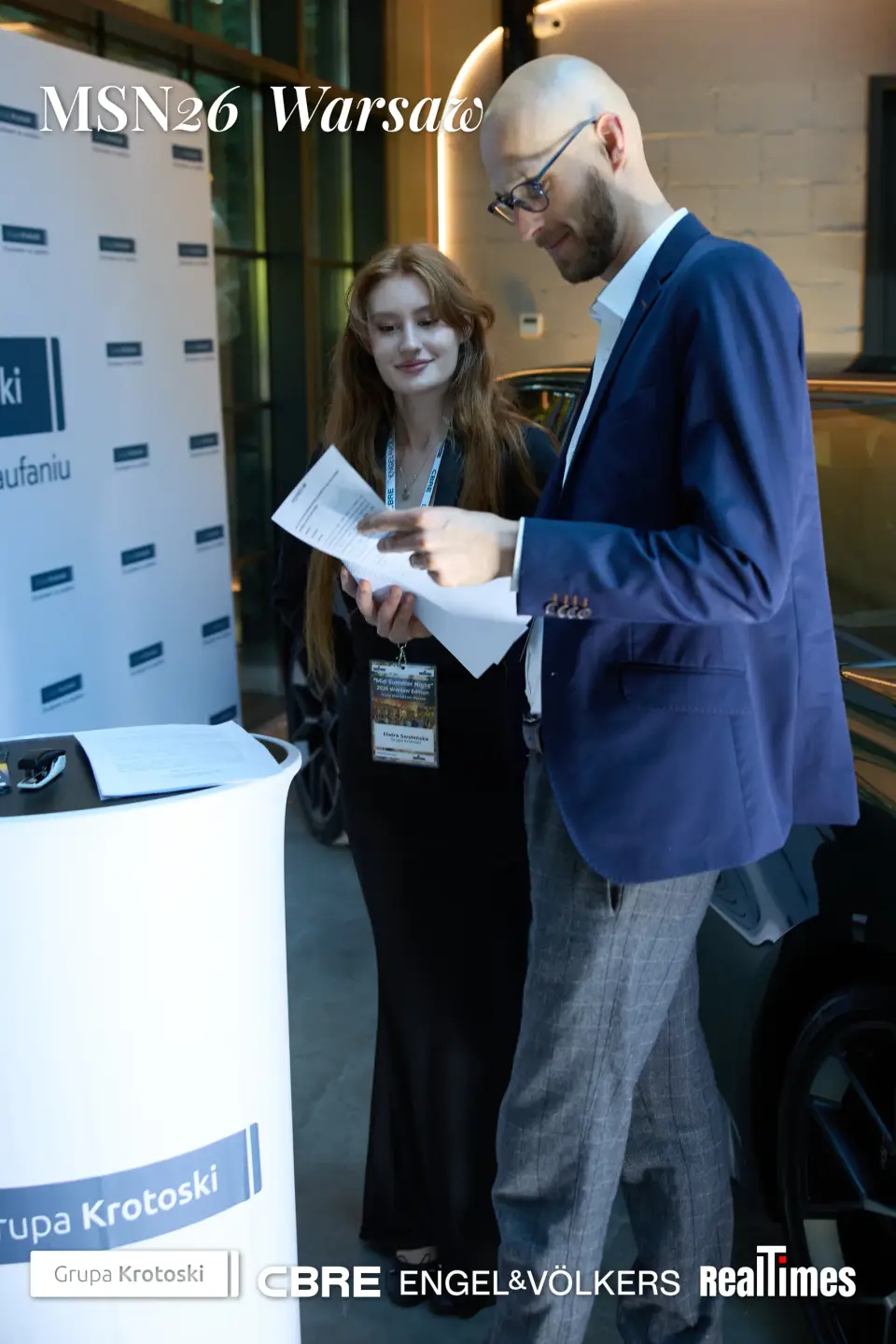Mid-Summer Night 2026 at B'Fort, Warsaw: pair by sponsor backdrop reading, networking