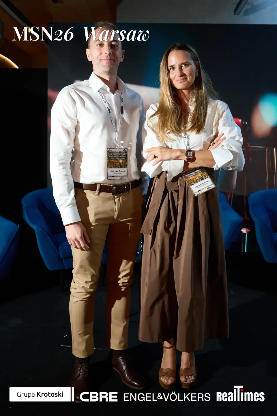 Mid-Summer Night 2026 at B'Fort, Warsaw: pair posed before Phoenix Awards backdrop | QA-adjudicated: networking/posed portrait, not stage