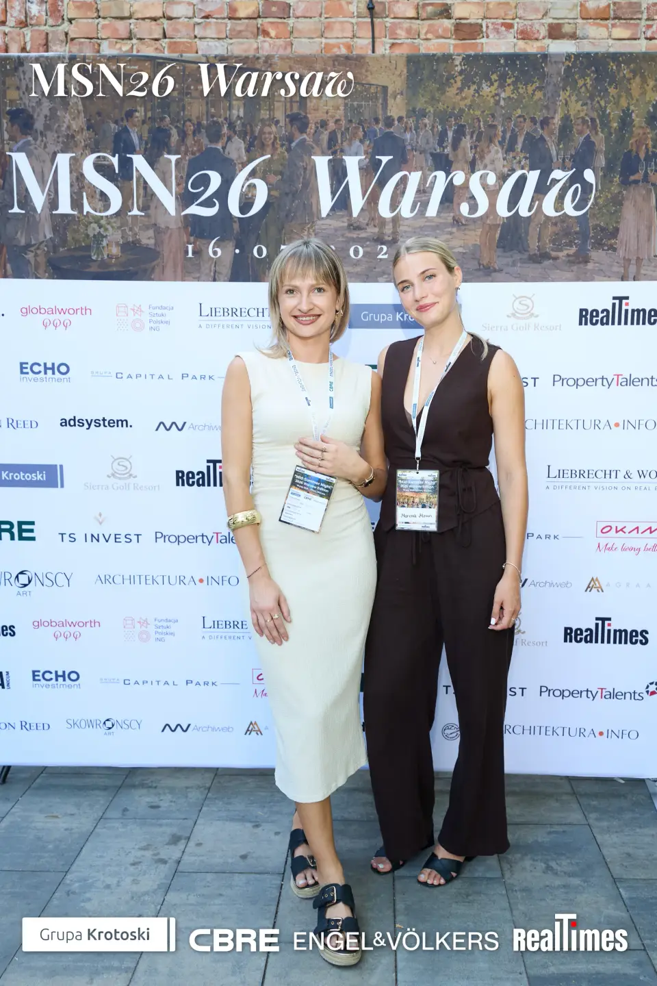 Mid-Summer Night 2026 at B'Fort, Warsaw: two women posing at MSN26 sponsor photowall